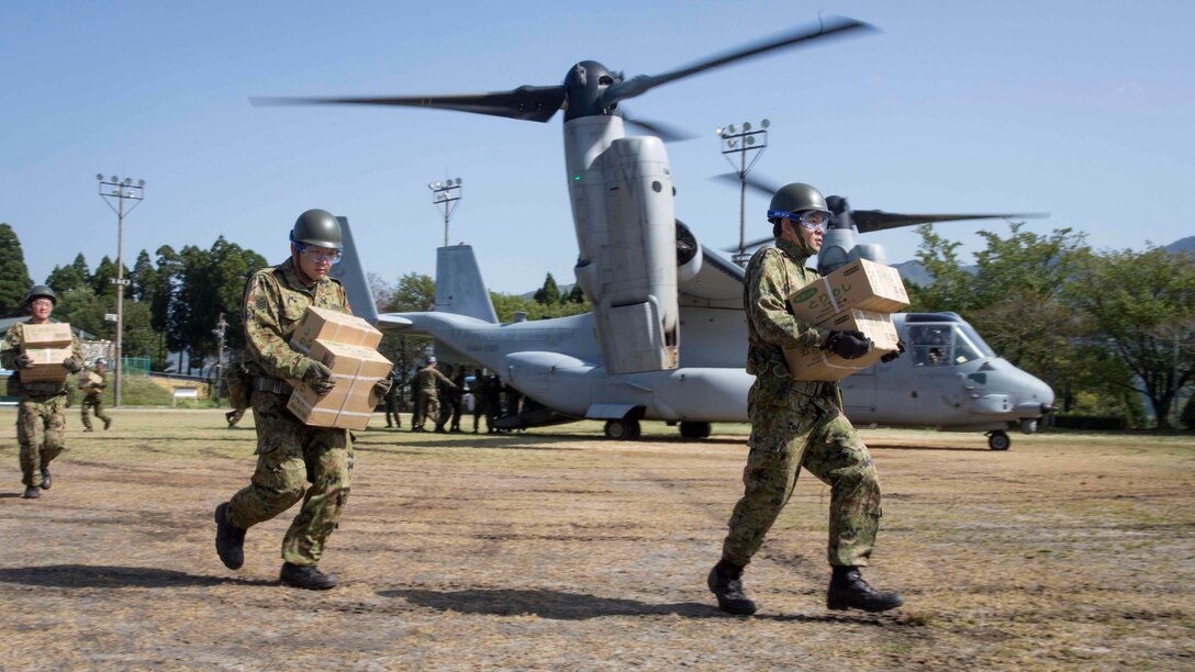 Japan Ground Self Defense Force personnel carry supplies from a U.S. Marine Corps MV-22B Osprey tiltrotor aircraft from Marine Medium Tiltrotor Squadron (VMM) 265 (Reinforced), 31st Marine Expeditionary Unit (MEU), in Hakusui Sports Park, Kyushu island, Japan, April 22, 2016. The supplies are in support of the relief effort after a series of earthquakes struck the island of Kyushu. The 31st MEU is the only continually forward-deployed MEU and remains the Marine Corps' force-in-readiness in the Asia-Pacific region. (U.S. Marine Corps photo by Cpl. Darien J. Bjorndal, 31st Marine Expeditionary Unit/ Released)