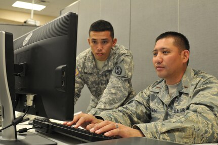 U.S. Army National Guard Staff Sgt. Vincent Iglesias of the 1/294th Infantry Battalion, and 2nd Lt. Tommy Rivera of the 254th Air Base Group, verified the login accounts of their fellow Blue Team 6 members, all from Guam, for a miniature exercise during Cyber Shield 2016 at Camp Atterbury, Ind., April 22, 2016. The MINIEX helped team members identify any issues and ensure all systems were up and running prior to the main exercise next week. Blue Team members combat the opposing forces of Red Team during cyber attack scenarios, which will be presented next week. (U.S. Army photo by Sgt. Stephanie A. Hargett)