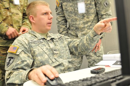 U.S. Army National Guard Warrant Officer Candidate Tyler Hightree, Nebraska Cyber Network Defense Team (CND-T) member, works with his teammates of Blue Team 18 during Cyber Shield 16 at Camp Atterbury, Ind., April 22, 2016. The Blue Team will combat the opposing forces of Red Team during cyber attack scenarios, which will be presented here next week. Cyber Shield is a two-week Army National Guard training exercise designed to develop and train cyber-capable forces. (U.S. Army photo by Sgt. Stephanie A. Hargett)