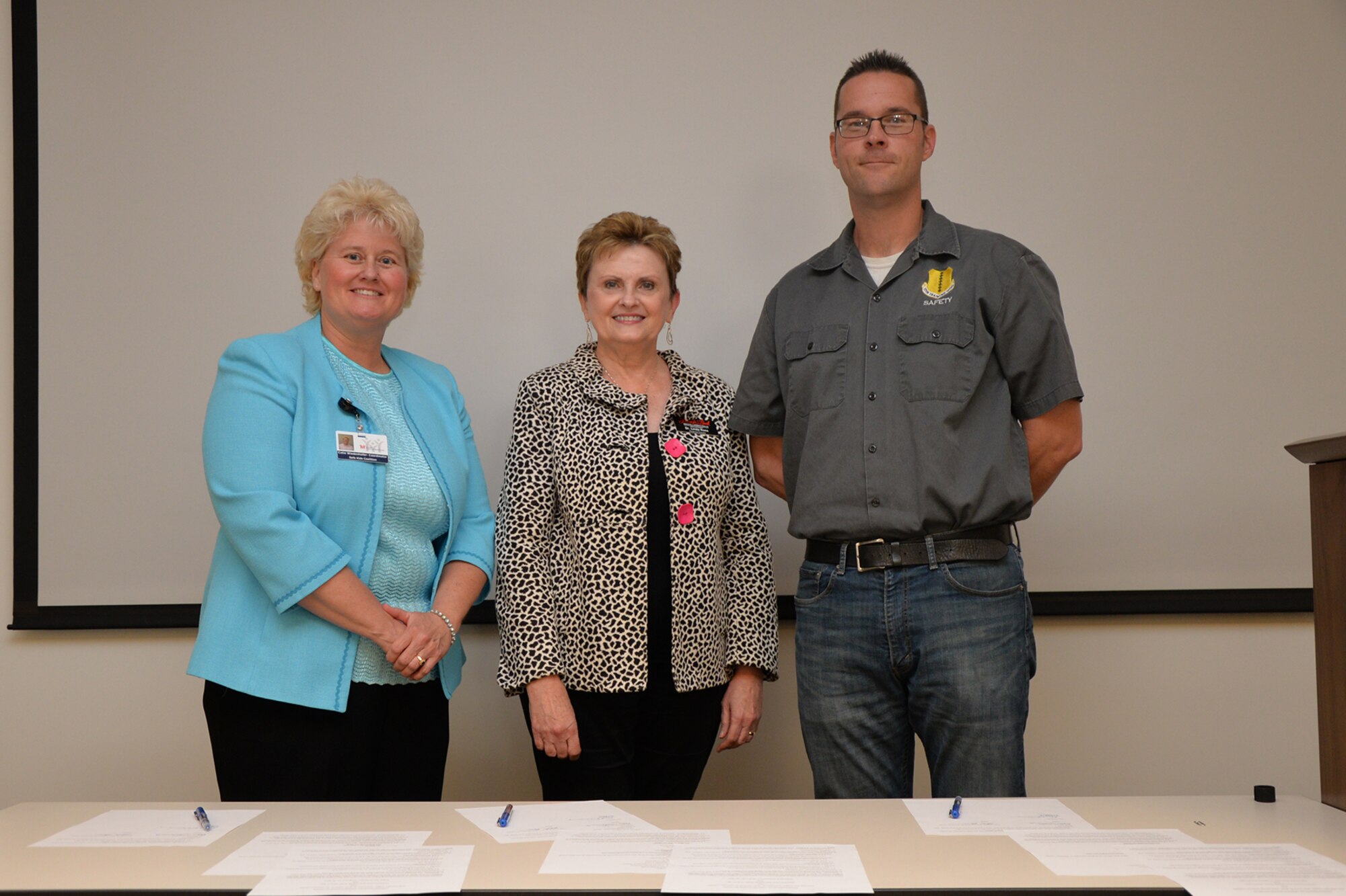Catie G. Wiedenhofer, Safe Kids San Angelo coordinator; Dr. Linda C. Ross, Laura W. Bush Institute for Women’s Health director; and Neil Townley, 17th Training Wing Safety chief, sign Memorandums of Understanding at the Devon Energy office in San Angelo, Texas, April 20, 2016.  The purpose of the Sharing Vehicles, Mechanics and Technicians MOU is to provide guidance and outline responsibilities regarding the City of San Angelo and the 17th Logistics Readiness Squadron’s sharing of resources for fire truck repair and ambulance service.  (U.S. Air Force photo by Airman 1st Class Randall A.S. Moose/Released) 
