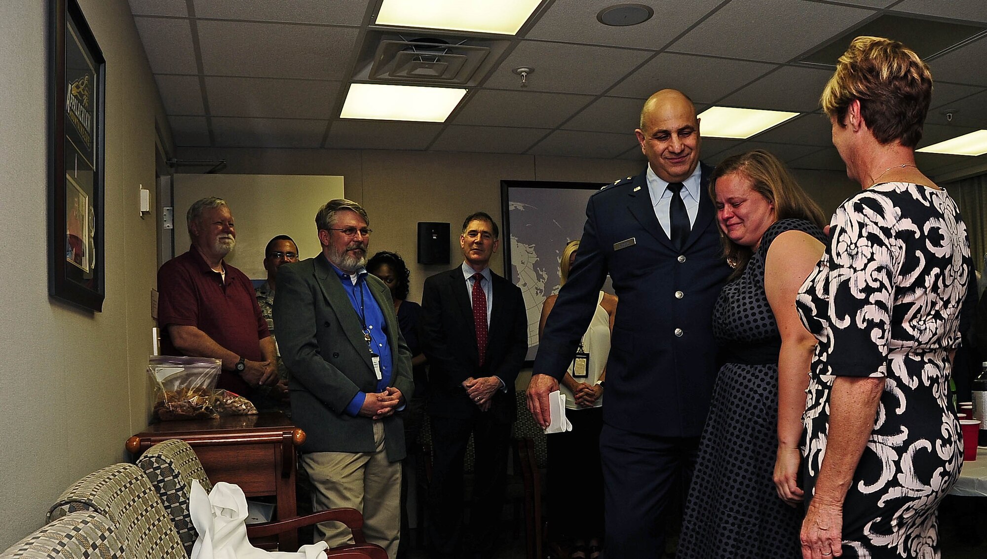 Maj. Gen. Richard S. Haddad, AFRC vice commander, embraces retired Lt. Col. Craig Branning's daughter during the dedication ceremony April 16 at HQ AFRC on Robins Air Force Base, Ga. Branning worked for 20 years as a military member and civil service employee in the Directorate of Strategic Plans, Programs and Requirements as chief of the strategic basing and total force branch and passed away in his office four years ago.  