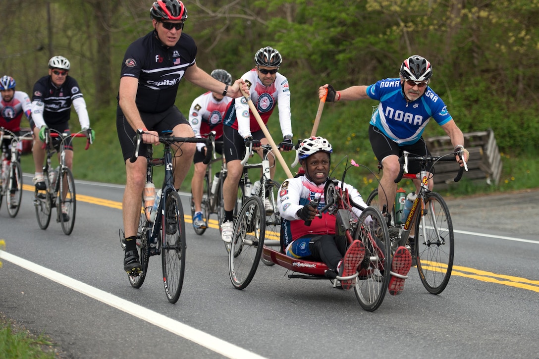 Retired Army Sgt. 1st Class Carl Morgan powers a handcycle with help from his teammates during the Face of America bike ride in Dickerson, Md., April 23, 2016. DoD photo by EJ Hersom