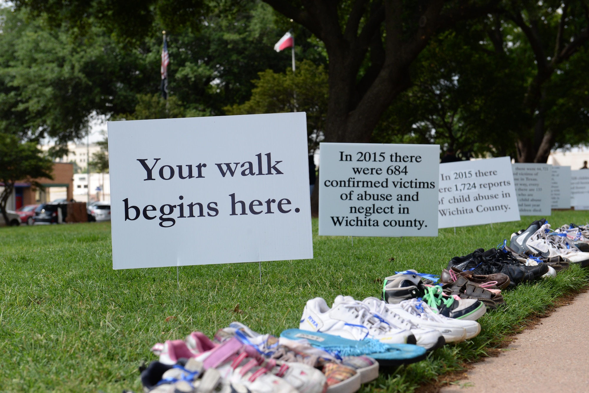 The Walk of Knowledge, an event raising awareness for Child Abuse Prevention Month, brings knowledge and insight to the issue of child abuse and neglect at the Wichita County Courthouse, Wichita Falls, Texas, April 15, 2016. The shoes represent the 684 cases of child abuse and neglect for Wichita County in 2015. (U.S. Air Force photo/2nd Lt. Brittany Curry)