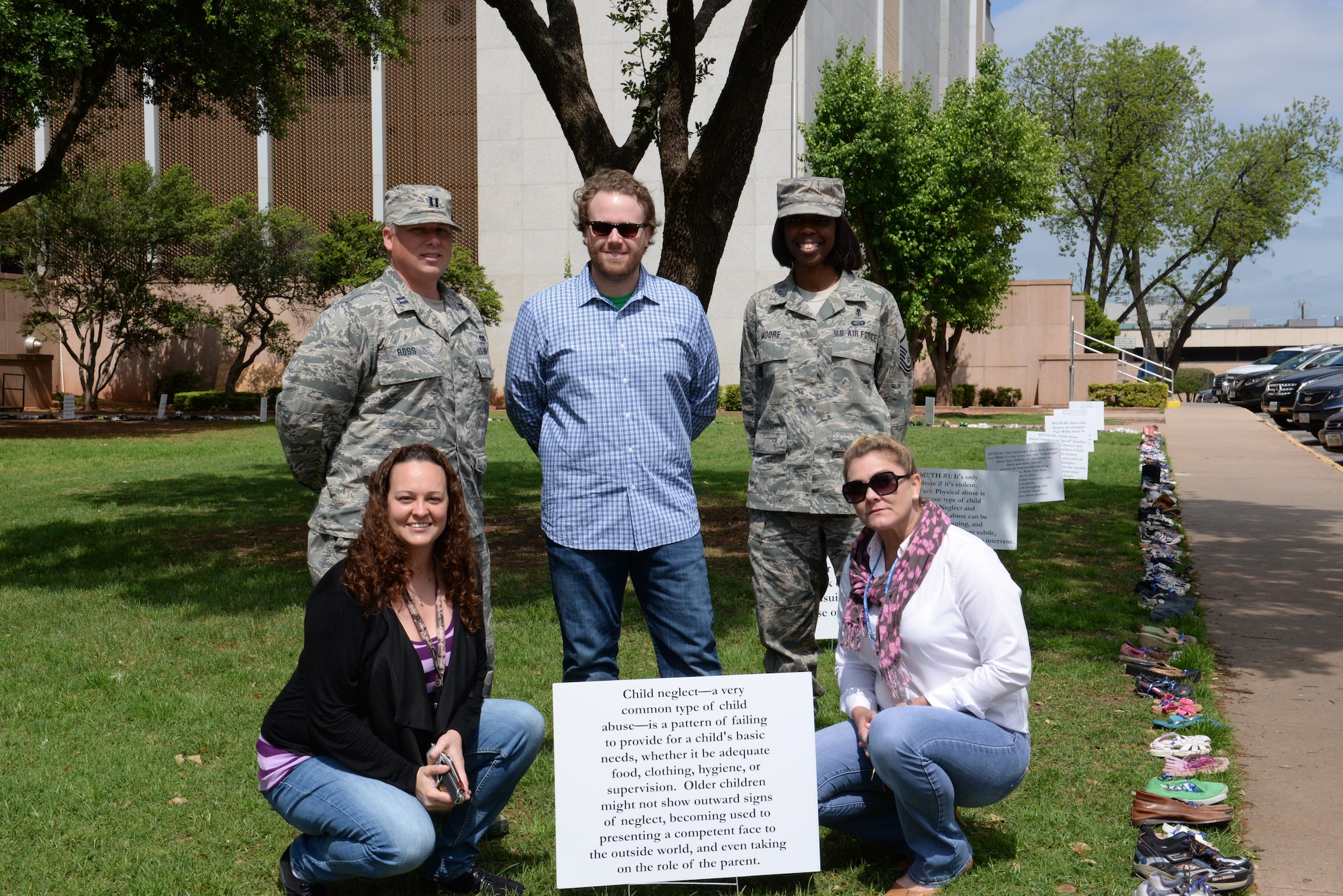 Members of the Sheppard Family Advocacy staff pose in front of a sign about child abuse and neglect at the Walk of Knowledge, an event to raise awareness for Child Abuse Prevention Month, at the Wichita County Courthouse, Wichita Falls, TX, April 15, 2016. Front Row (Left to right): Tiffany Esparza, Family Advocacy Outreach manager, Amy McGee, Family Advocacy Program and Outreach assistant. Back Row (Left to right): Capt. Jason Ross, Mental Health flight commander, Austin Solomons, Social Worker, Master Sgt. Toya Moore, Mental Health flight chief.