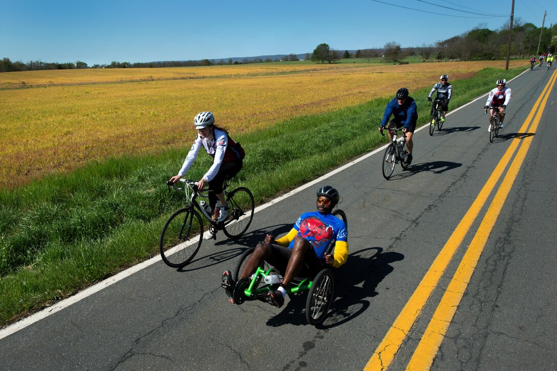 Retired Army Chief Warrant Officer 4 Duane Wallace, foreground right, leads a pack of cyclists during the Face of America bike ride near Gettysburg, Pa., April 24, 2016. DoD photo by EJ Hersom