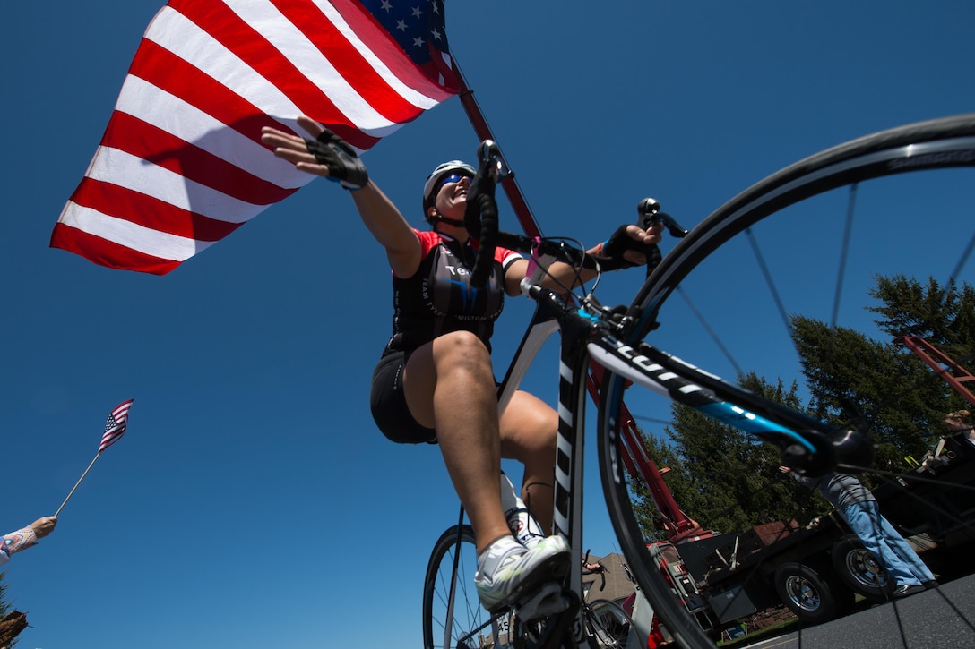 A bicyclist waves to supporters during the Face of America bike ride in Gettysburg, Pa., April 24, 2016. DoD photo by EJ Hersom
