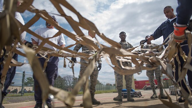 Members of the 305th Aerial Port Squadron and Federal Emergency Management Agency’s Pennsylvania Task Force 1 load cargo onto pallets during training April 21, 2016, at Joint Base McGuire-Dix-Lakehurst, N.J. Mobile teams consisting of approximately 80 personnel, trained in search and rescue, extraction and triage care, as well as relief workers deploy to aid affected communities. The joint base is Pennsylvania Task Force 1’s point of departure should they need to be airlifted. (U.S. Air Force photo/Staff Sgt. Katherine Tereyama)