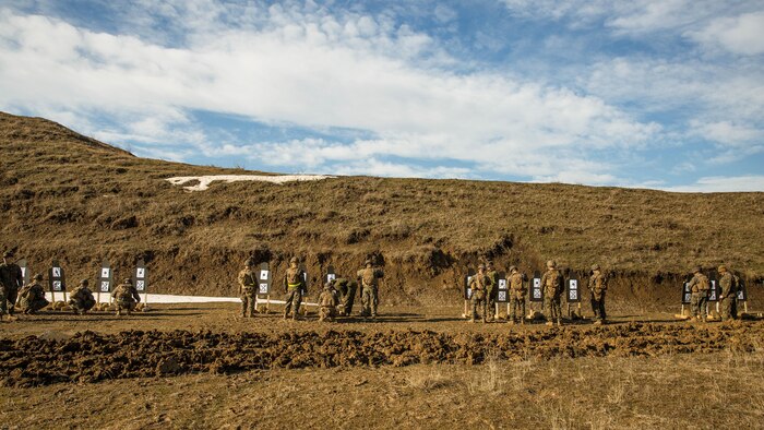 U.S. Marines with Black Sea Rotational Force review their shot groups during a live-fire exercise aboard Mihail Kognalniceanu Air Base, Romania, Feb. 2, 2016. Marines from 1st Battalion, 8th Marine Regiment, conducted battle sight zeroes on various individual weapons systems, to prepare for future BSRF exercises and contingencies. 