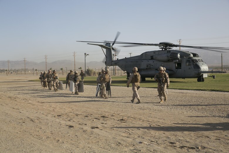 Marines with Combat Logistics Battalion 24 off load from a CH-53 ‘Super Stallion’ at Del Valle Field aboard the Combat Center, as part of a Non-combatant Evacuation Operation exercise in support of Weapons and Tactics Instructor Course 2-16 April 15, 2016. (Official Marine Corps photo by Cpl. Thomas Mudd/Released)