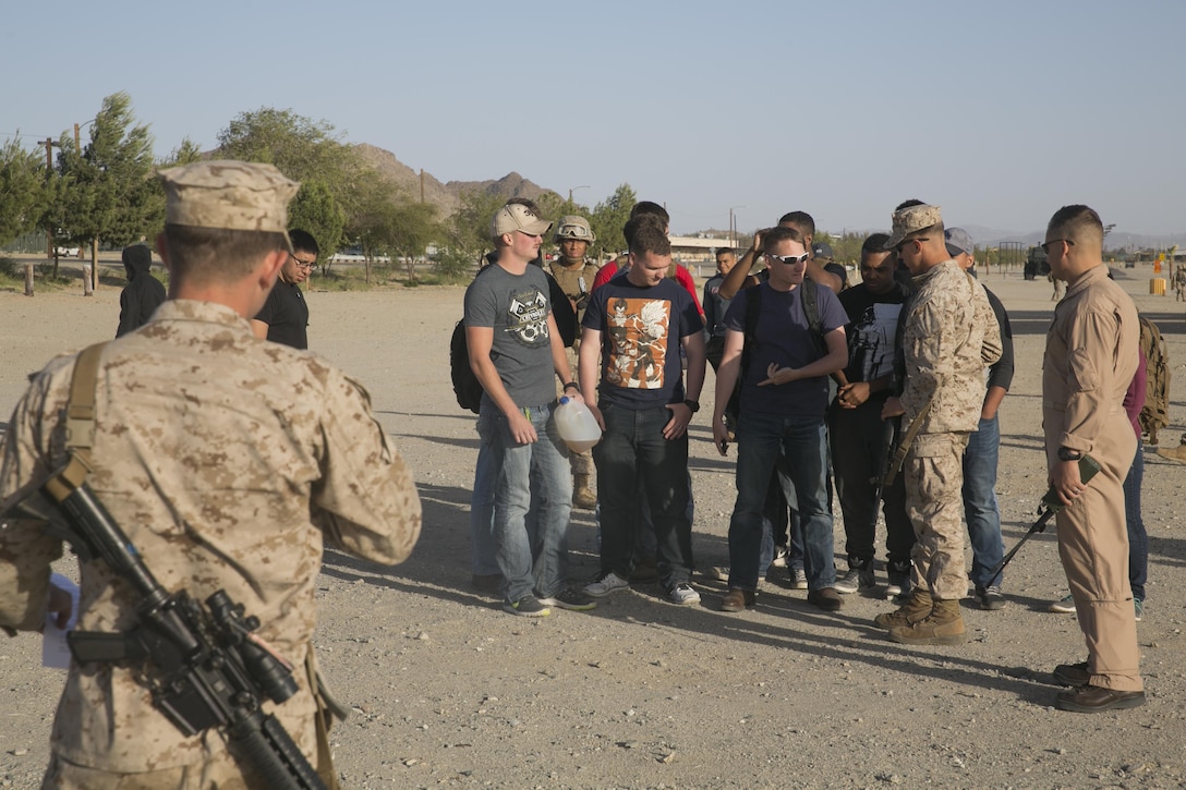 Marine role-players begin their screening to board an aircraft for extraction at Del Valle Field aboard the Combat Center, as part of a Non-combatant Evacuation Operation exercise in support of Weapons and Tactics Instructor Course 2-16 April 15, 2016. (Official Marine Corps photo by Cpl. Thomas Mudd/Released)