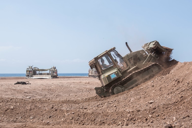 U.S. Marine Lance Cpl. Nicholas Bouvia, a heavy equipment operator with the 13th Marine Expeditionary Unit, builds a berm for security in Djibouti, Apr. 9, 2016. The 13th MEU is conducting sustainment training to maintain proficiency and combat readiness while deployed with the Boxer Amphibious Ready Group during Western Pacific Deployment 16-1. (U.S. Marine Corps photo by Cpl. Alvin Pujols/RELEASED)