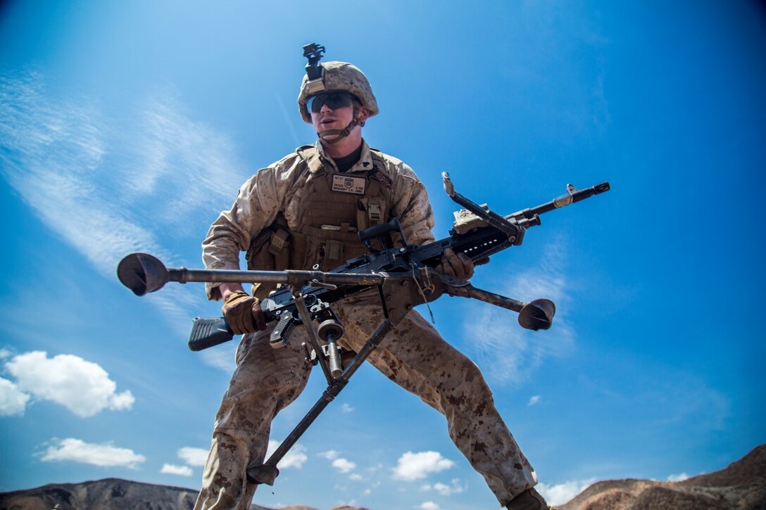 A U.S. Marine with the 13th Marine Expeditionary Unit, picks up his M-240 Bravo to maneuver to a new firing position during weapons familiarization training and drills on Range TC-02 during Western Pacific Deployment 16-1, Djibouti, Africa, April 17, 2016. The Marines are conducting weapons familiarization training and drills while in Djibouti to stay mission ready while in the SECOM area of operation.  (U.S. Marine Corps photo by Sgt. Hector de Jesus/RELEASED)