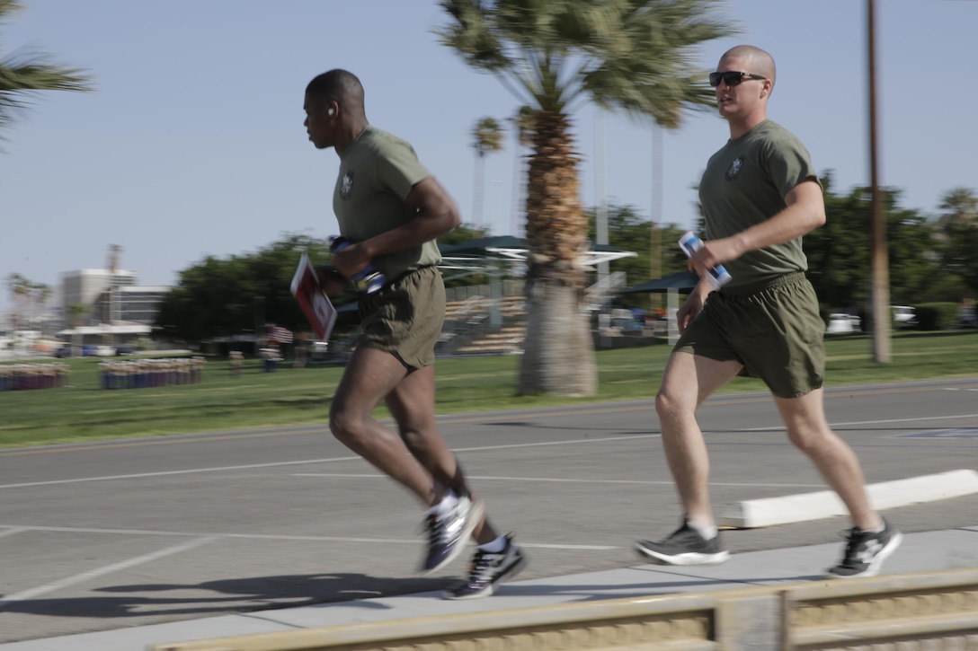 Lance Cpl. Elijah Kelly, rifleman and Lance Cpl. Abram Martin, mortar-man, 2nd Battalion, 7th Marine Regiment, run past Lance Cpl. Torrey L. Gray Field during Substance Abuse Program Scavenger Hunt April 15, 2016. (Official Marine Corps photo by Pfc. Dave Flores/Released)