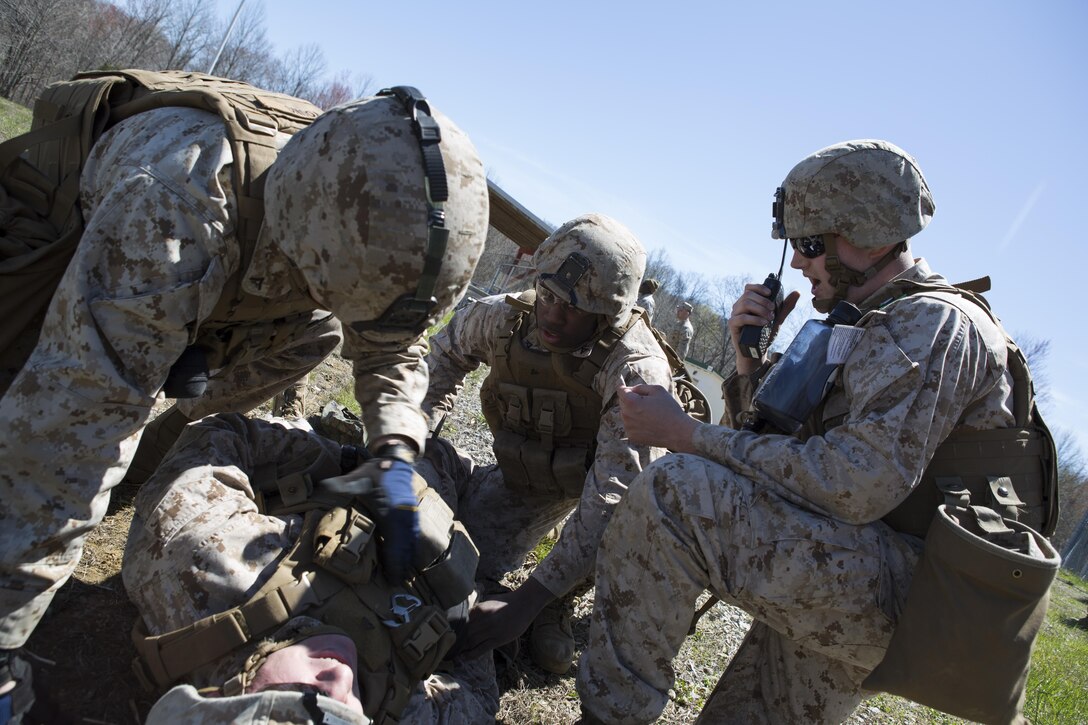 Reserve Marines with 2/24, 23rd Marine Regiment, 4th Marine Division, Marine Forces Reserve and Anti-Tank Training Company, 4th MarDiv, MFR, call in a casualty evacuation drill during a fire support coordination exercise, in Camp Atterbury, Ind., April 13, 2016. The Marines trained various individual skills and mission essential tasks during the exercise including participation in a combined, anti-armor team range. 