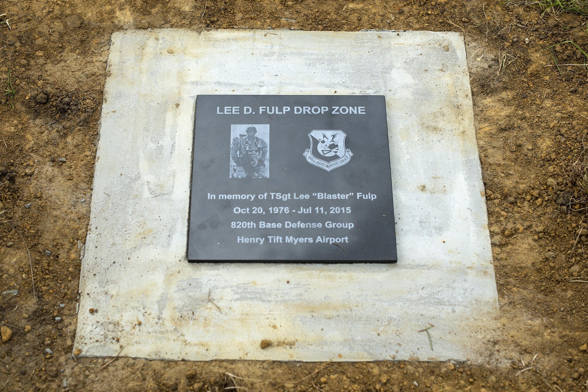 A plaque rests on the newly dedicated Lee D. Fulp Drop Zone, April 21, 2016, at Henry Tift Myers Airport, Tifton, Ga. Tech. Sgt. Lee Fulp served in the 820th Defense Group as an Explosive Ordnance Disposal NCO in charge. (U.S. Air Force photo by Airman 1st Class Janiqua P. Robinson/Released)