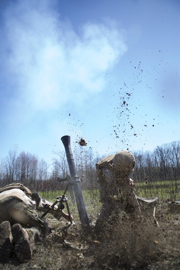 Lance Cpl. Gerald Potempa (right) and Lance Cpl. Brent Madison (left), mortar men with 2/24 Battalion, 23rd Marine Regiment, 4th Marine Division, Marine Forces Reserve, fire the 81 mm gun during a fire support coordination exercise at Camp Atterbury, Ind., April 14, 2016. The Marines coordinated with forward observers to provide suppressive fire with mortars while aviation assets, provided by air national guard units, destroyed the target.
