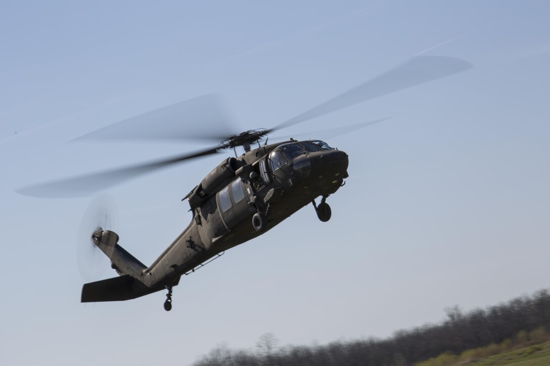 A Blackhawk with the U.S. Army, Company B, 8th Battalion, 229th Aviation Regiment (8-229 AV), 11th Aviation Command (Theater),  flies by to pick up scout sniper Marines with 2/24, 23rd Marine Regiment, 4th Marine Division, Marine Forces Reserve, during a fire support coordination exercise in Camp Atterbury, Ind.,  April 14, 2016. The Reserve Marines coordinated with the U.S. Army and Air National Guard units to provide assault support to the Marines. 