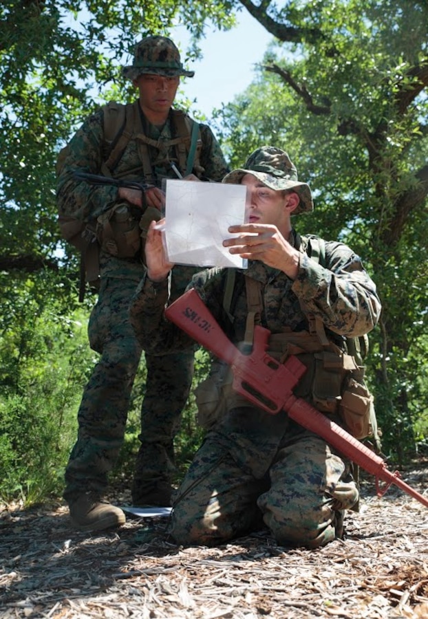 Petty Officer 2nd Class Thomas O. Dugan (left), a hospital corpsman with Headquarters and Service Company, 6th Engineer Support Battalion, 4th Marine Logistics Group, Marine Forces Reserve, and Petty Officer 2nd Class Adam C. Wild (right), a hospital corpsman and instructor for the Basic Medical Technician Corpsman Program, Medical Education and Training Campus, check a map at  a land navigation exercise during a Fleet Marine Force reconnaissance corpsman screening in San Antonio, April 21, 2016. 