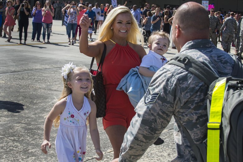 U.S. Air Force Staff Sgt. Michael Lane, 23d Equipment Maintenance Squadron munitions inspector, greets his family after returning from a deployment, April 22, 2016, at Moody Air Force Base, Ga. More than 250 Airmen returned home after a six-month deployment to Europe. (U.S. Air Force photo by Airman Daniel Snider/Released)