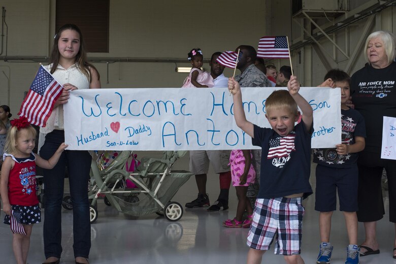 U.S. Air Force Senior Airman Anton Wilder's, 476th Maintenance Squadron, family and friends celebrate his return home from a deployment, April 22, 2016, at Moody Air Force Base, Ga. Airmen returned from overseas where they carried out close air support missions with the A-10C Thunderbolt II. (U.S. Air Force photo by Airman Daniel Snider/Released)
