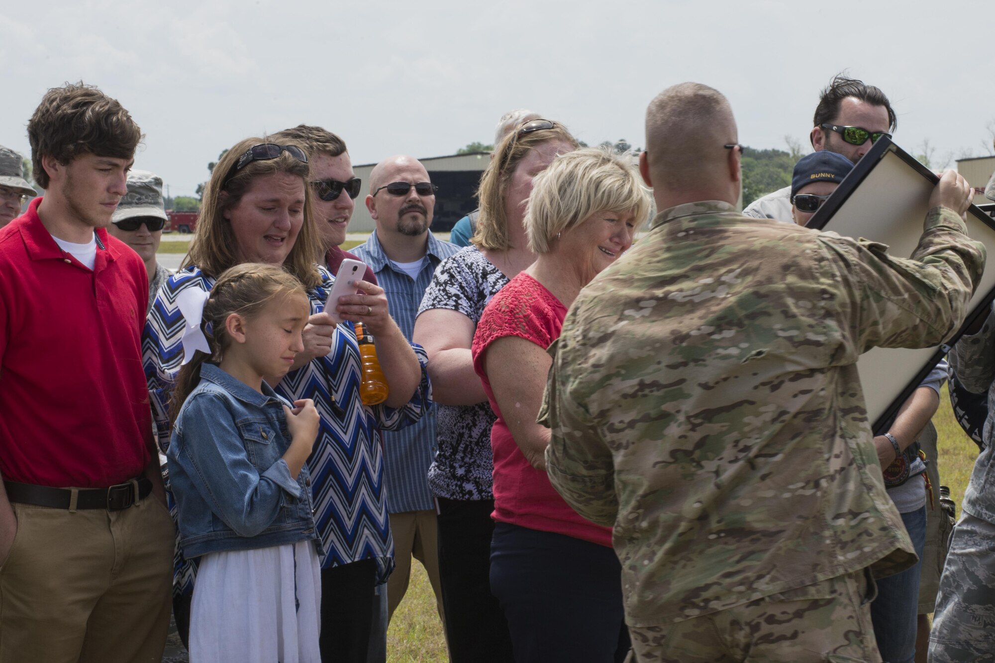 Family of U.S. Air Force Tech. Sgt. Lee Fulp receive a framed photo of the drop zone during a memorial jump ceremony, April 21, 2016, at Henry Tift Myers Airport, Tifton, Ga. The airport dedicated the drop zone to Fulp, who passed away in a motorcycle accident July 11, 2015. (U.S. Air Force photo by Airman Daniel Snider/Released)