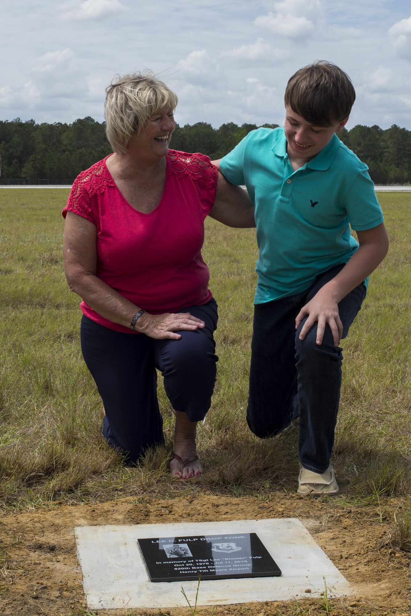 U.S. Air Force Tech. Sgt. Lee Fulp’s mother, Sheila, and son, Hunter, share a laugh during a memorial jump ceremony, April 21, 2016, at Henry Tift Myers Airport, Tifton, Ga. The 820th Base Defense Group performed the jump and landed in the newly designated Lee D. Fulp Drop Zone dedicated to the fallen Moody Airman. (U.S. Air Force photo by Airman Daniel Snider/Released)