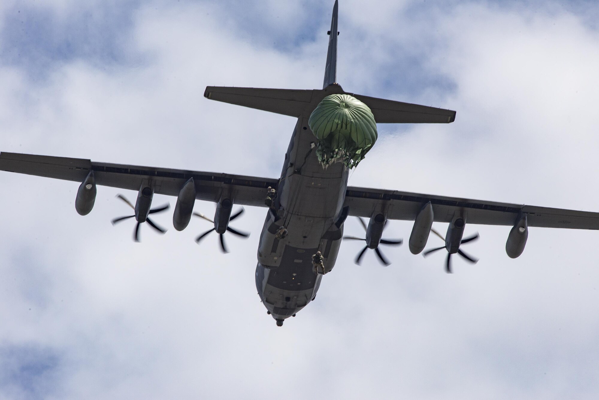 U.S. Air Force Airmen from the 820th Base Defense Group parachute out of a HC-130J Combat King II during a memorial jump ceremony, April 21, 2016, at Henry Tift Myers Airport, Tifton, Ga. More than 35 Airmen jumped in memory of Tech. Sgt. Lee Fulp, who instructed combatives for 820th Combat Operations Squadron. (U.S. Air Force photo by Airman Daniel Snider/Released)
