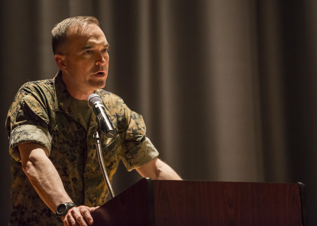 Col. Joseph T. Allena, the commanding officer of 10th Marines Regiment, addresses his Marines and Sailors gathered at the base theater for a child abuse awareness and prevention symposium at Camp Lejeune, N.C., April 22, 2016. The purpose of the symposium was to make the Marines aware of the various resources available to them through their units and Marine Corps Community Services. (U.S. Marine Corps photo by Cpl. Michelle Reif/Released.)