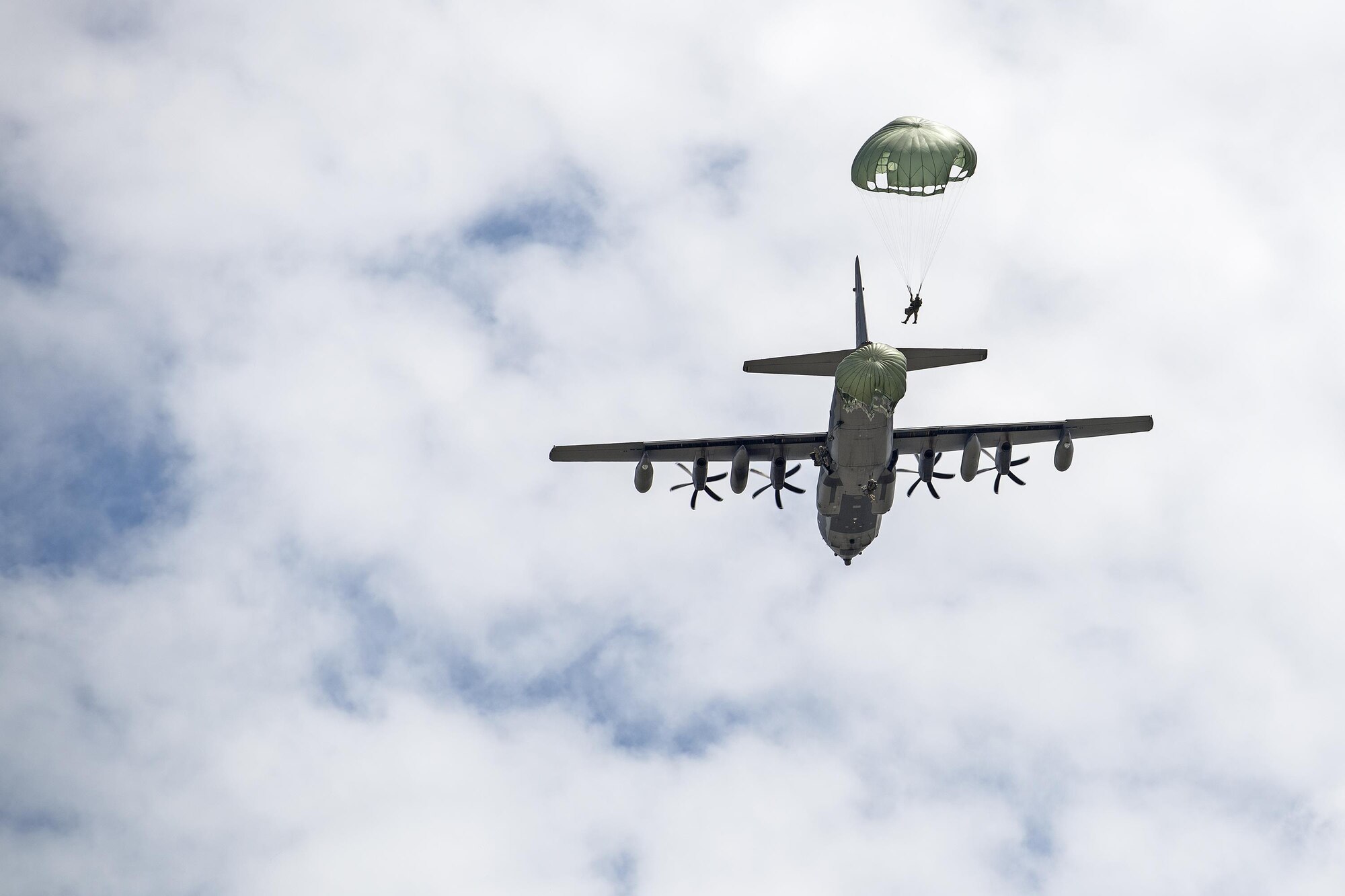 U.S. Air Force Airmen from the 820th Base Defense Group jump out of an HC-130J Combat King II during a memorial jump ceremony, April 21, 2016, at Henry Tift Myers Airport, Tifton, Ga. More than 35 Airmen jumped to honor the memory of Tech. Sgt. Lee D. Fulp. (U.S. Air Force photo by Airman 1st Class Janiqua P. Robinson/Released)