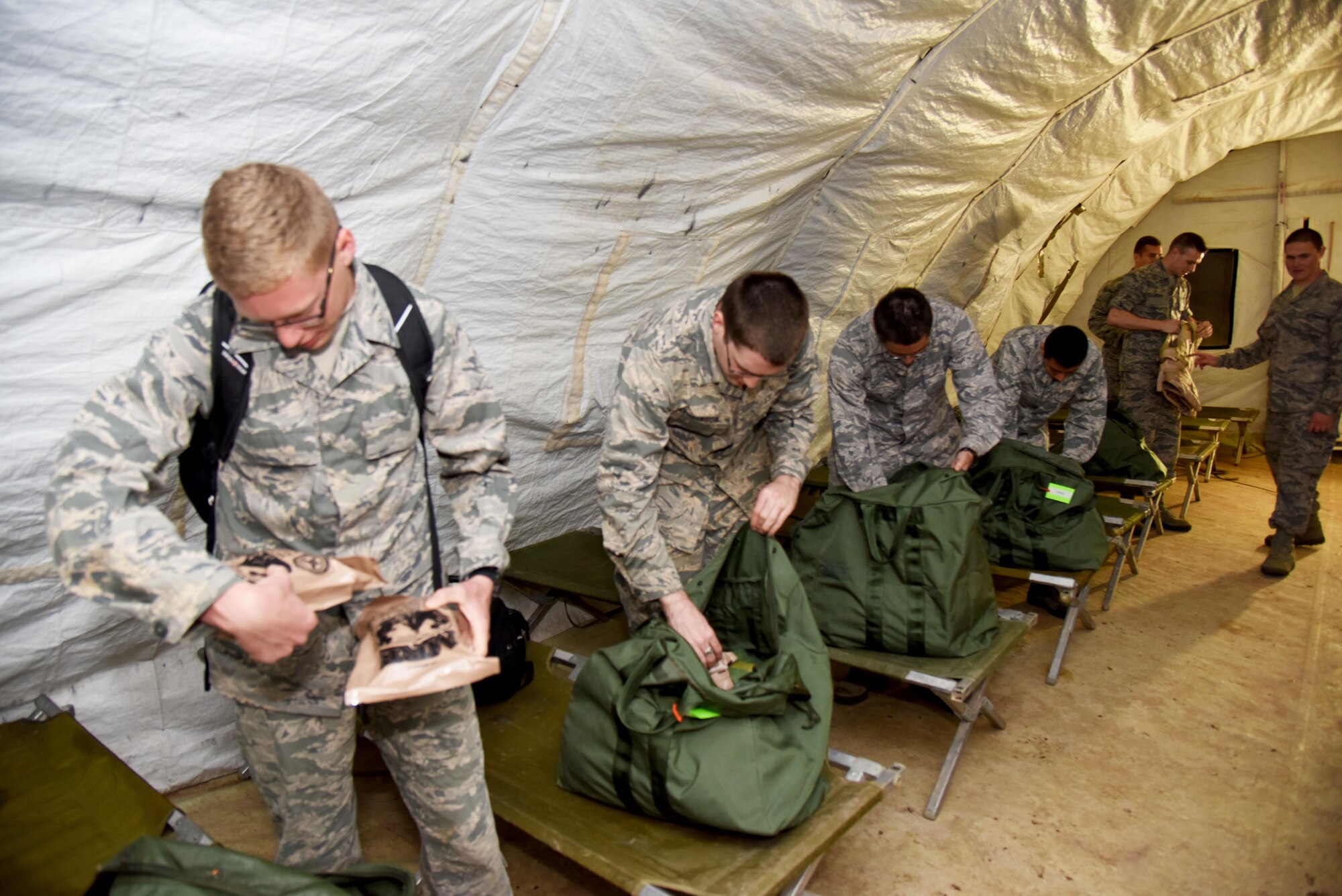Angelo State University Air Force ROTC Detachment 847 cadets check their gear before a field training exercise at Camp Sentinel on Goodfellow Air Force Base, Texas, April 22, 2016. The FTX is an annual event designed to build cadets leadership capabilities. (U.S. Air Force photo by Senior Airman Joshua Edwards/Released)