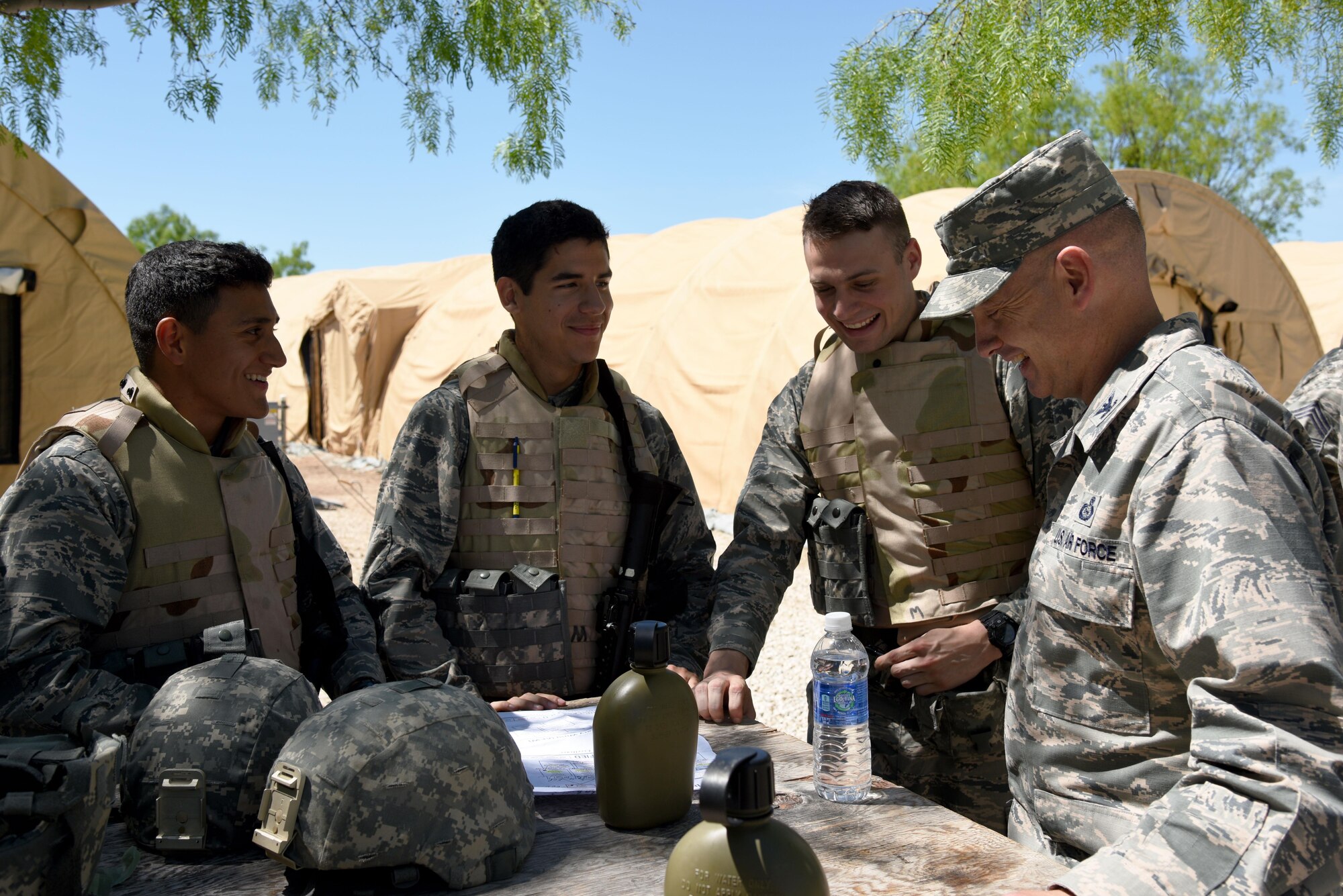 U.S. Air Force Col. Michael L. Downs, 17th Training Wing Commander, visits Angelo State University Air Force ROTC Detachment 847 cadets during a field training exercise at Camp Sentinel on Goodfellow Air Force Base, Texas, April 22, 2016. Downs acted as a regional commander during the exercise and met individuals role-playing as friendly foreign locals. (U.S. Air Force photo by Senior Airman Joshua Edwards/Released)