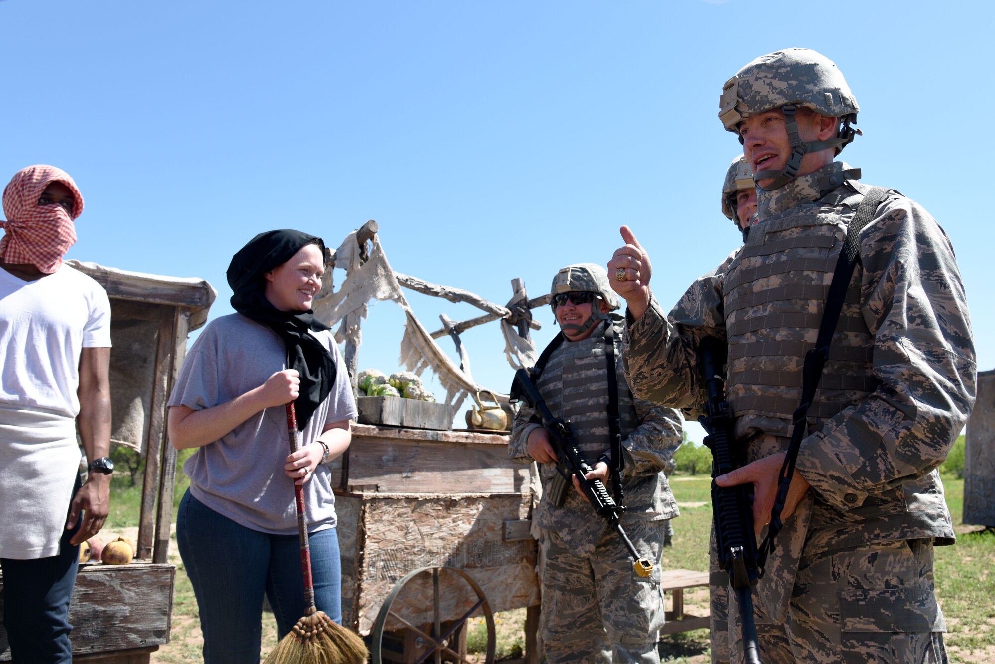 U.S. Air Force Col. Michael L. Downs, 17th Training Wing Commander, meets with role-players acting as friendly locals of a foreign land during an Angelo State University Air Force ROTC Detachment 847 field training exercise at Camp Sentinel on Goodfellow Air Force Base, Texas, April 22, 2016. Downs acted as a liaison for the role-players and provided guidance to the ASU Air Force ROTC cadets. (U.S. Air Force photo by Senior Airman Joshua Edwards/Released)