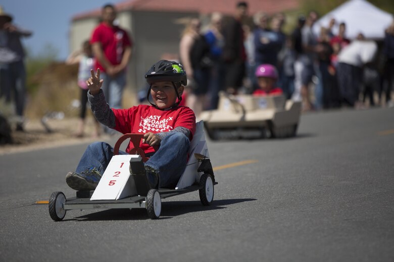 Frank D. Hernandez, 9, son of Staff Sgt. Frank Hernandez, instructor, Communication Training Battalion, races downhill during the Twentynine Palms Car Show and Street Fair at Luckie Park in Twentynine Palms, Calif., April 16, 2016. (Official Marine Corps photo by Cpl. Julio McGraw/Released)