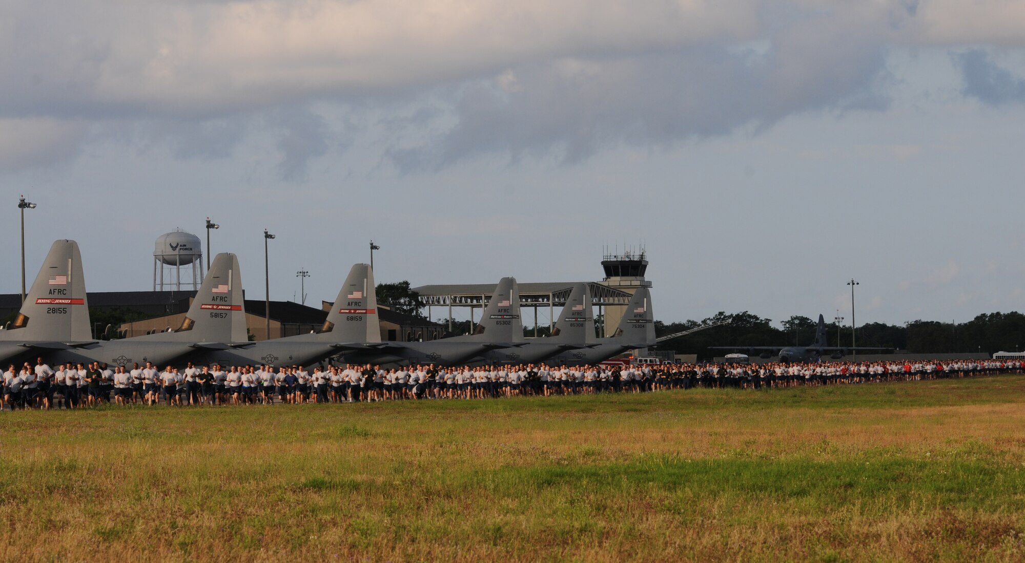 Keesler Airmen run around the flightline during a 5K run April 25, 2016, Keesler Air Force Base, Miss. The run was the kickoff event for a week full of activities supporting Wingman Week. (U.S. Air Force photo by Kemberly Groue)