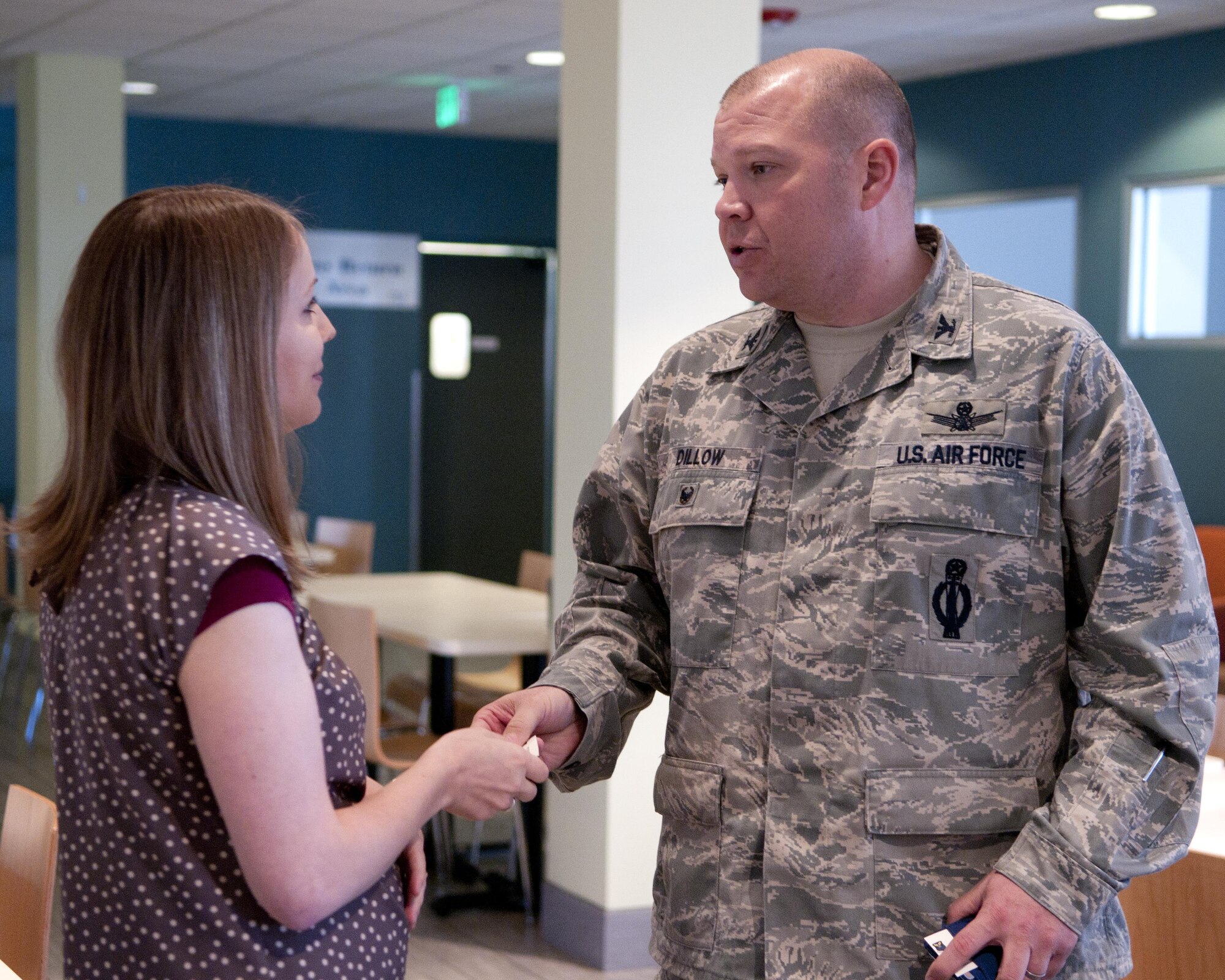 Col. Matt Dillow, 90th Missile Wing vice commander, speaks with Ali Hobson, wife of Staff Sgt. Joshua Hobson, 388th Maintenance Group on Hill Air Force Base, Utah, after she told her story for the Sexual Assault Prevention and Response office’s Survivors Speak Breakfast, April 22, 2016, in the Chadwell Dining Facility on F.E. Warren Air Force Base, Wyo. Dillow lead the event with his opening remarks to show his support for the SAPR program. (U.S. Air Force photo by Airman 1st Class Malcolm Mayfield)