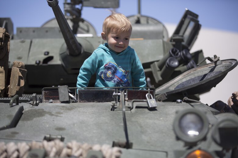 Matias Ryals, 2, son of Jacky and Devon Ryals, residents of Twentynine Palms, climbs out of the driver’s seat of a Light Armored Reconnaissance Vehicle during the Twentynine Palms Car Show and Street Fair at Luckie Park in Twentynine Palms, Calif., April 16, 2016. (Official Marine Corps photo by Cpl. Julio McGraw/Released)