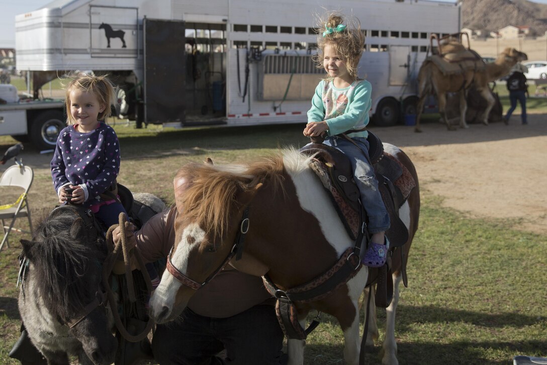 Combat Center children ride ponies during the Earth Day Extravaganza at Lincoln Military Housing Athletic Field April 15, 2016. (Official Marine Corps photo by Cpl. Connor Hancock/Released)