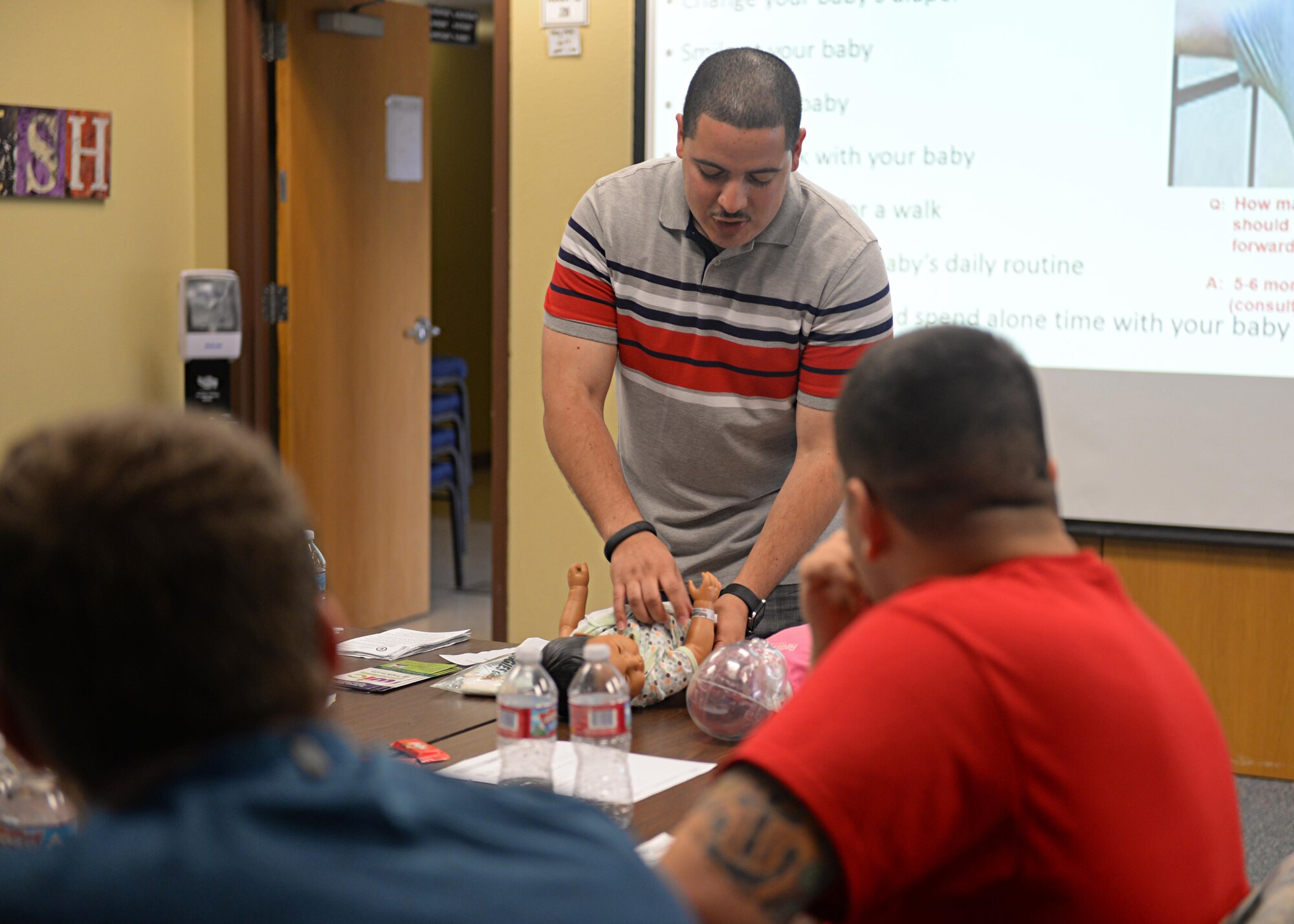 Staff Sgt. Daniel Mendez, 9th Reconnaissance Wing Equal Opportunity director and Dads 101 instructor, demonstrates how to properly change a baby during a Dads 101 class April 22, 2016, at Beale Air Force Base, California. The course is designed to assist all fathers; soon to be, new and multiple children fathers with pre and post-birth of their newborn. Some of the topics the course covers are diaper changing, handling newborns, building attachment and ways to assist their spouse. (U.S. Air Force photo by Senior Airman Ramon A. Adelan) 