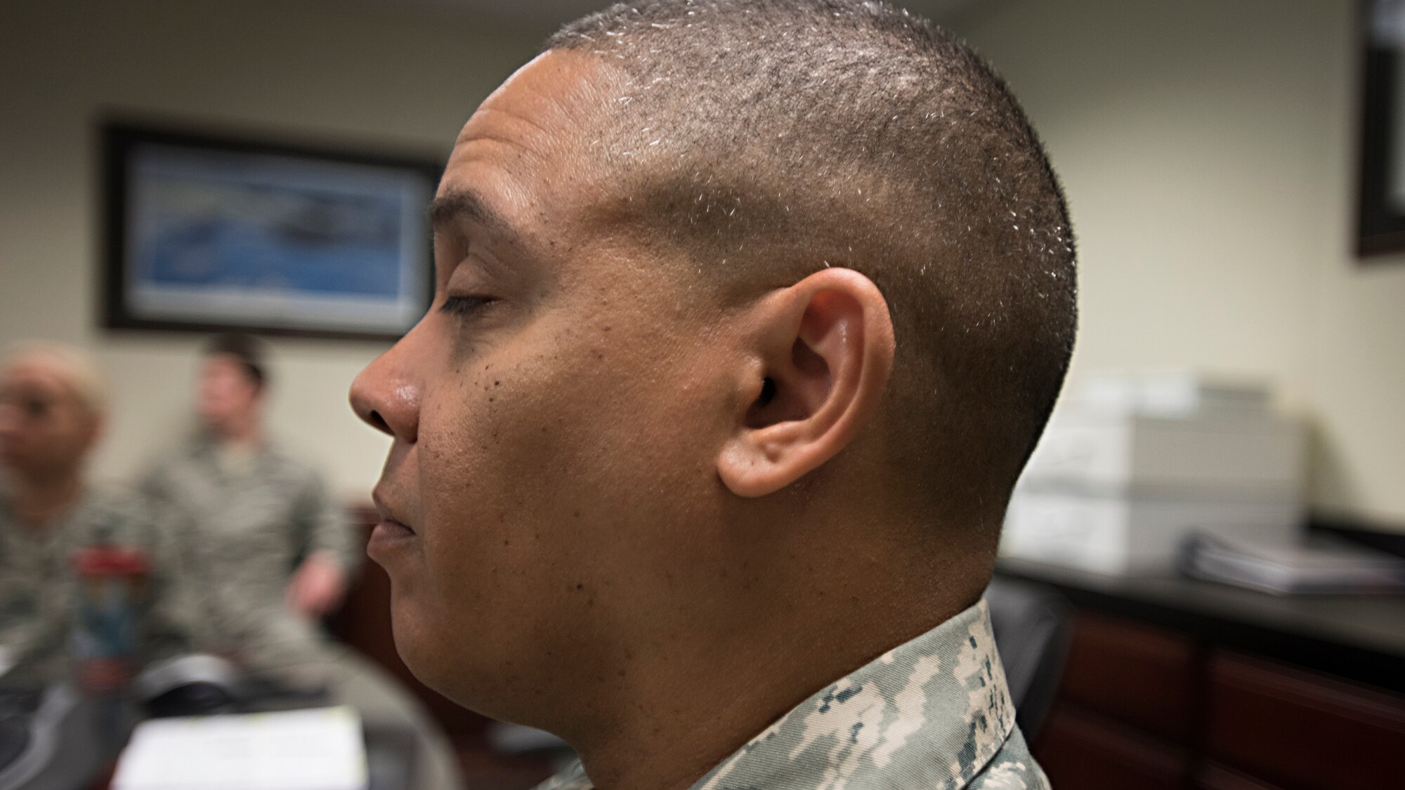 A member of the 305th OSS leadership team participates in a “Mindful Minute” meditation session during a staff meeting April 20, 2016 at Joint Base McGuire-Dix-Lakehurst, N.J. The Mindful Minute is part of an ongoing mindful initiative to improve the mental fitness of Airmen. (U.S. Air Force photo by Staff Sgt. Katherine Tereyama)