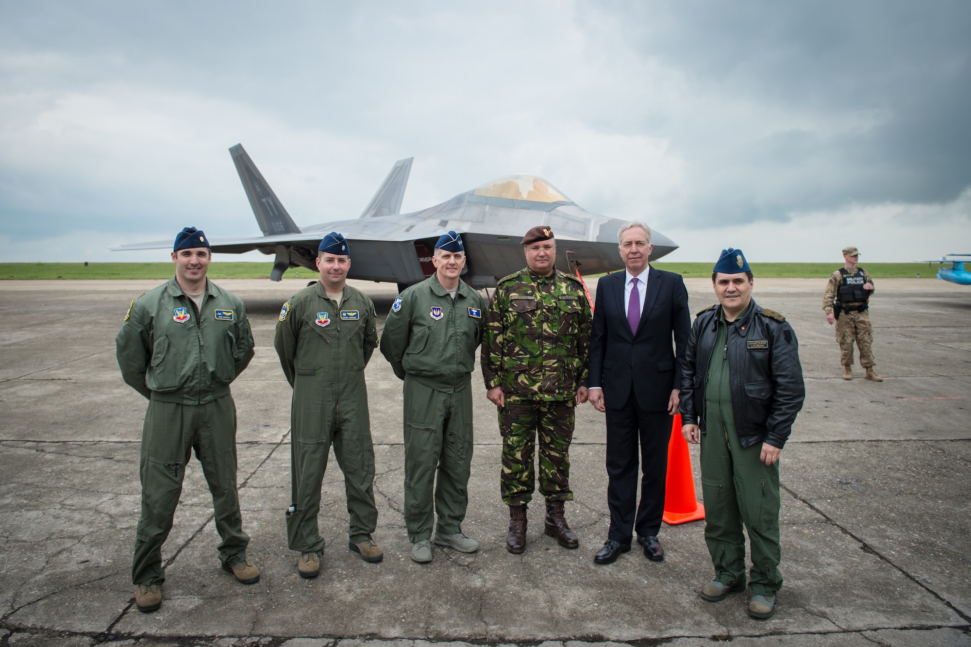 Senior Romanian and U.S leadership pose for a photo in front of the F-22A Raptors that forward deployed to Mihail Kogalniceanu Air Base, Romania, April 25, 2016. The aircraft will conduct air training with other Europe-based aircraft and will also forward deploy from England to maximize training opportunities while demonstrating the U.S. commitment to NATO allies and the security of Europe. The Raptors are deployed from the 95th Fighter Squadron, Tyndall Air Force Base, Florida. (U.S. Air Force photo by Tech. Sgt. Ryan Crane/Released)
