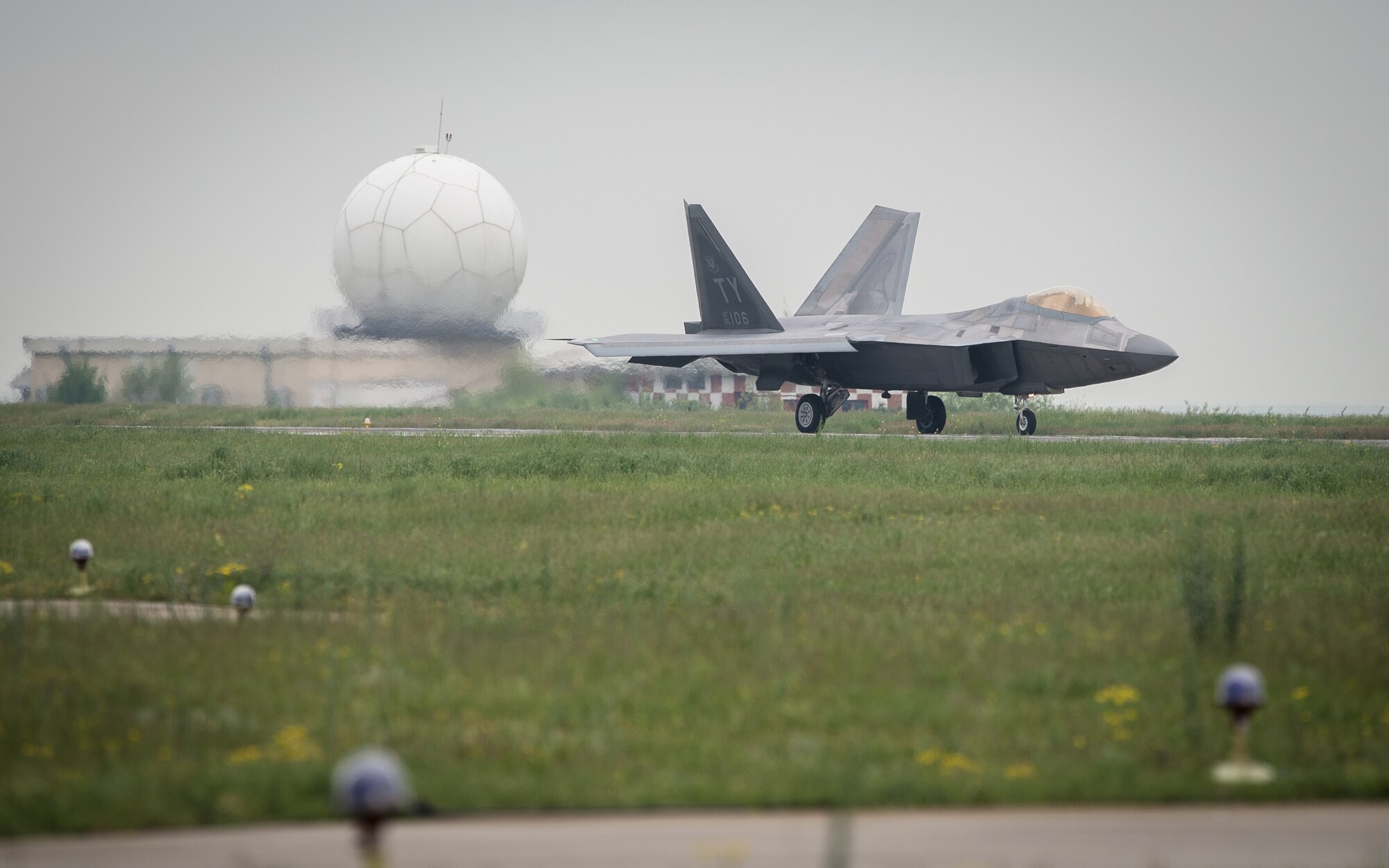 A U.S. Air Force F-22A Raptor taxis on the flightline at Mihail Kogalniceanu Air Base, Romania, April 25, 2016. The aircraft will conduct air training with other Europe-based aircraft and will also forward deploy from England to maximize training opportunities while demonstrating the U.S. commitment to NATO allies and the security of Europe. The Raptors are deployed from the 95th Fighter Squadron, Tyndall Air Force Base, Florida. (U.S. Air Force photo by Tech. Sgt. Ryan Crane/Released)
