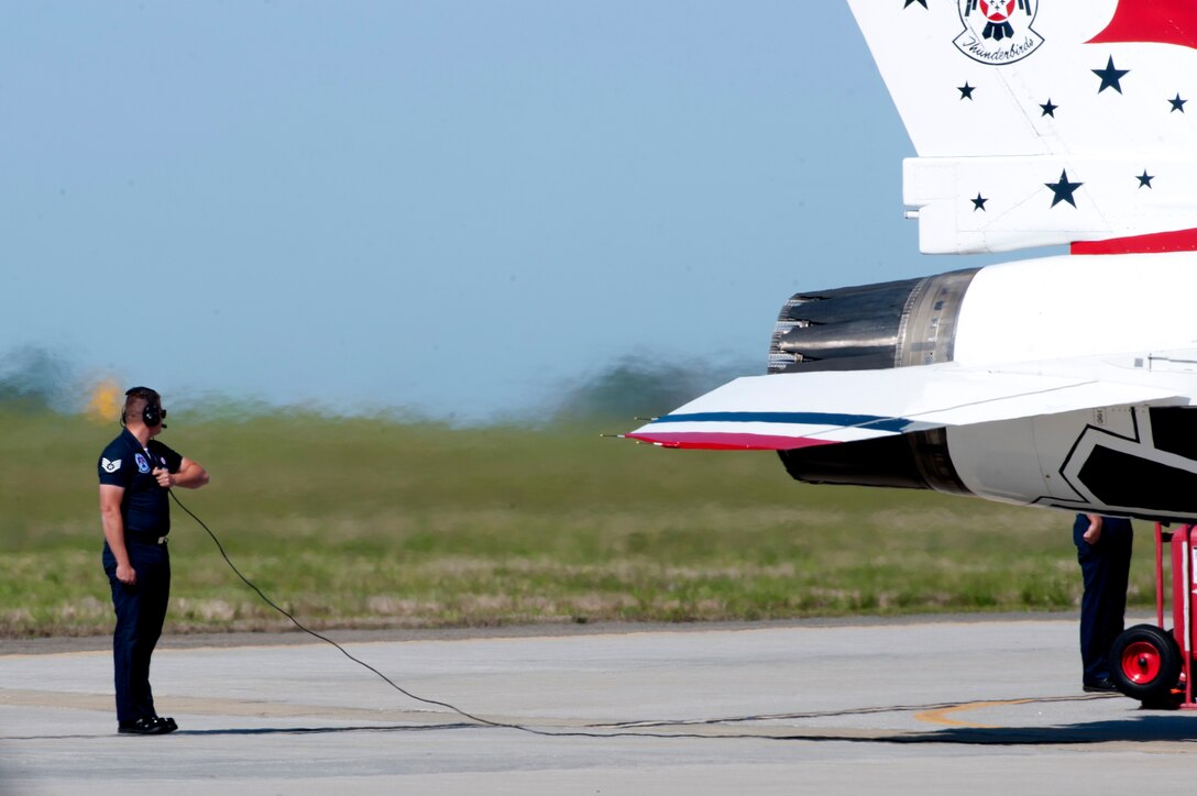 A U.S. Air Force Thunderbirds team member helps prepare a jet for take off during the AirPower over Hampton Roads Open House at Langley Air Force Base, Va., April 24, 2016. The Thunderbirds Show Line consists of 24 professionals in various aircraft maintenance specialties and they are selected before each demonstration season based on their job proficiency, dedication to duty, and overall attitude. (U.S. Air Force photo by Senior Airman R. Alex Durbin)