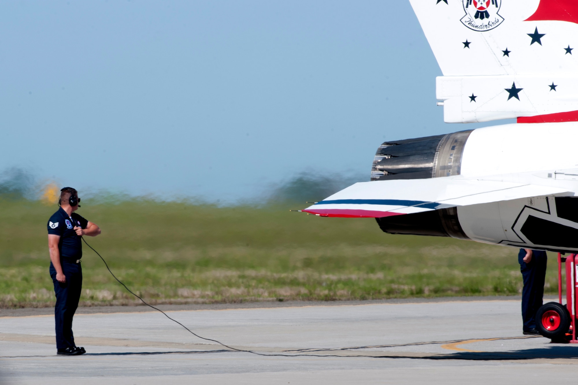 A U.S. Air Force Thunderbirds team member helps prepare a jet for take off during the AirPower over Hampton Roads Open House at Langley Air Force Base, Va., April 24, 2016. The Thunderbirds Show Line consists of 24 professionals in various aircraft maintenance specialties and they are selected before each demonstration season based on their job proficiency, dedication to duty, and overall attitude. (U.S. Air Force photo by Senior Airman R. Alex Durbin)