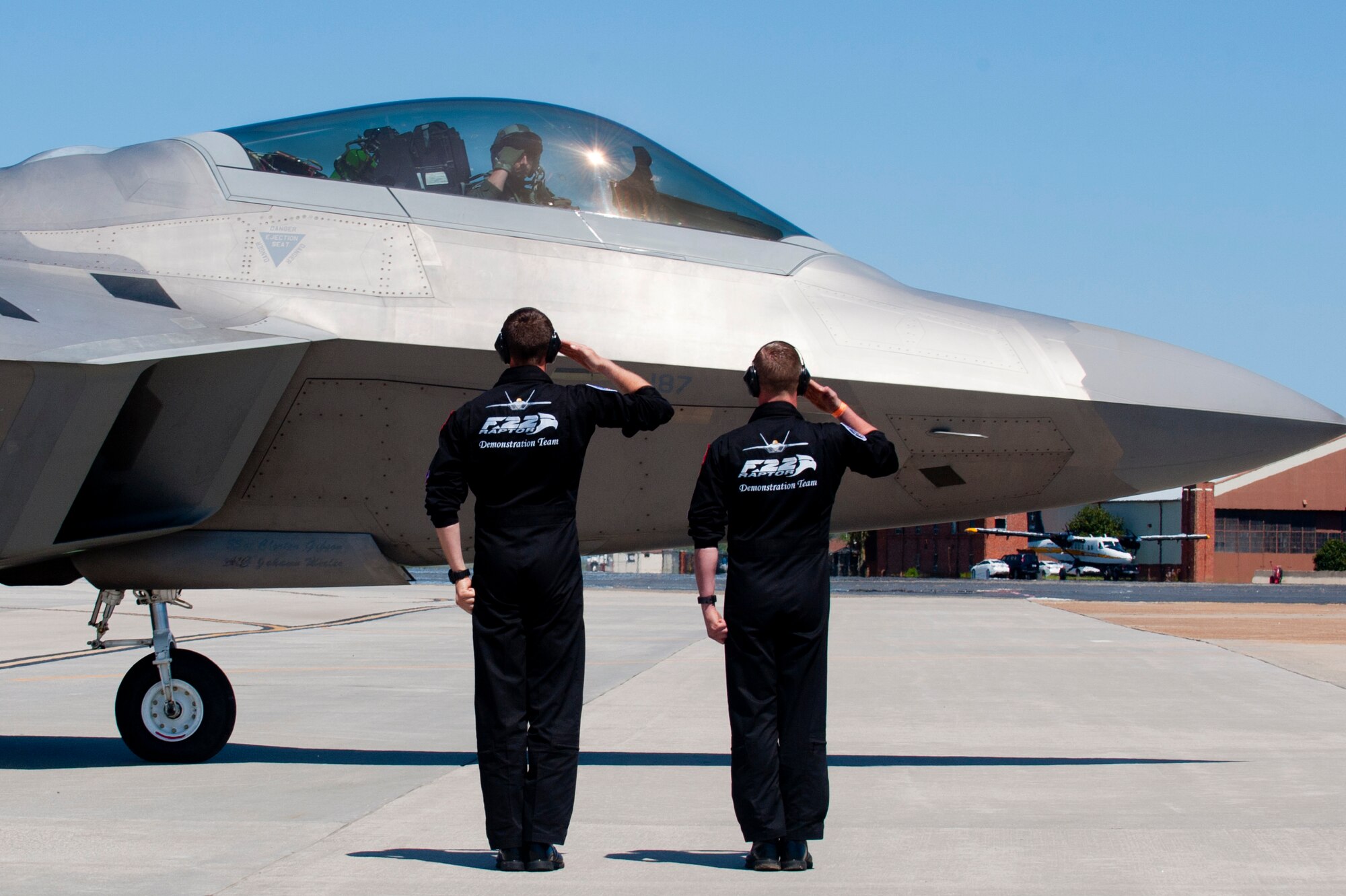 Members of the Air Combat Command F-22 Raptor Demonstration Team exchange salutes prior to take off during the AirPower over Hampton Roads Open House at Langley Air Force Base, Va., April 24, 2016. The Raptor performs both air-to-air and air-to-ground missions allowing full realization of operational concepts vital to the 21st century Air Force. (U.S. Air Force photo by Senior Airman R. Alex Durbin)