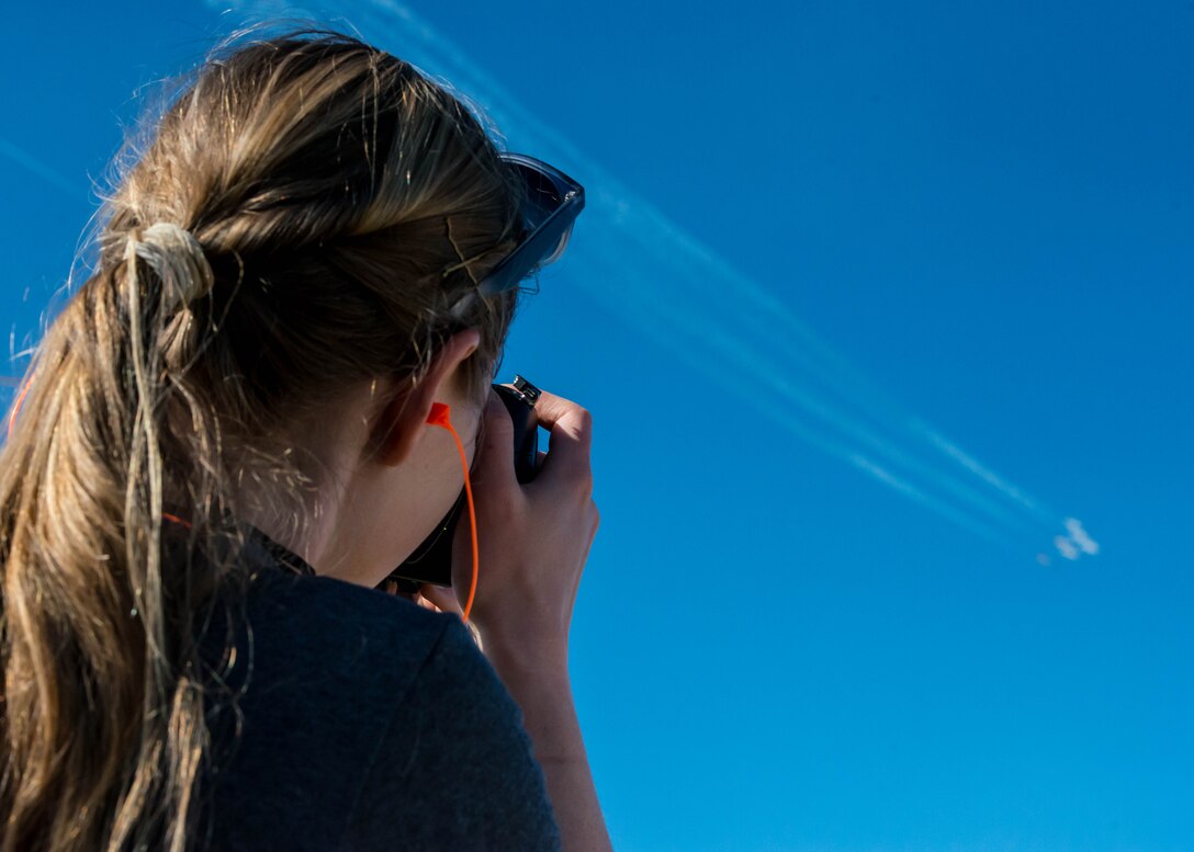 U.S. Air Force Staff Sgt. Natasha Stannard, a photojournalist assigned to the 633rd Air Base Wing Public Affairs office captures a photo of the U.S. Air Force Thunderbirds during the Airpower Over Hampton Roads Open House at Langley Air Force Base, Va., April 24, 2016. This was Stannard’s second time documenting an open house; her first was in 2011 at Fairchild Air Force Base.  (U.S. Air Force photo by Staff Sgt. J.D. Strong II)