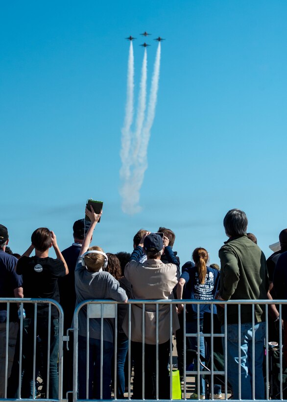 Spectators watch and take photos as the U.S. Air Force Thunderbirds fly overhead during the AirPower over Hampton Roads Open House at Langley Air Force Base, Va., April 24, 2016. More than 300 million people in all 50 states and 58 foreign countries have seen the Thunderbirds perform in more than 4,000 aerial demonstrations. (U.S. Air Force photo by Staff Sgt. J.D. Strong II)