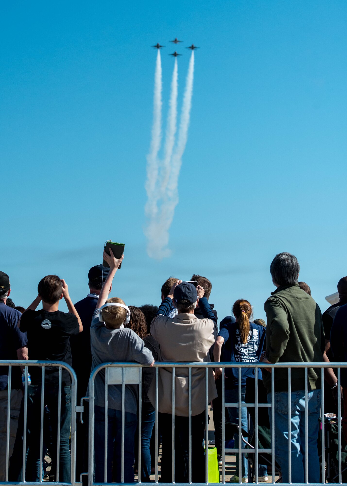 Spectators watch and take photos as the U.S. Air Force Thunderbirds fly overhead during the AirPower over Hampton Roads Open House at Langley Air Force Base, Va., April 24, 2016. More than 300 million people in all 50 states and 58 foreign countries have seen the Thunderbirds perform in more than 4,000 aerial demonstrations. (U.S. Air Force photo by Staff Sgt. J.D. Strong II)