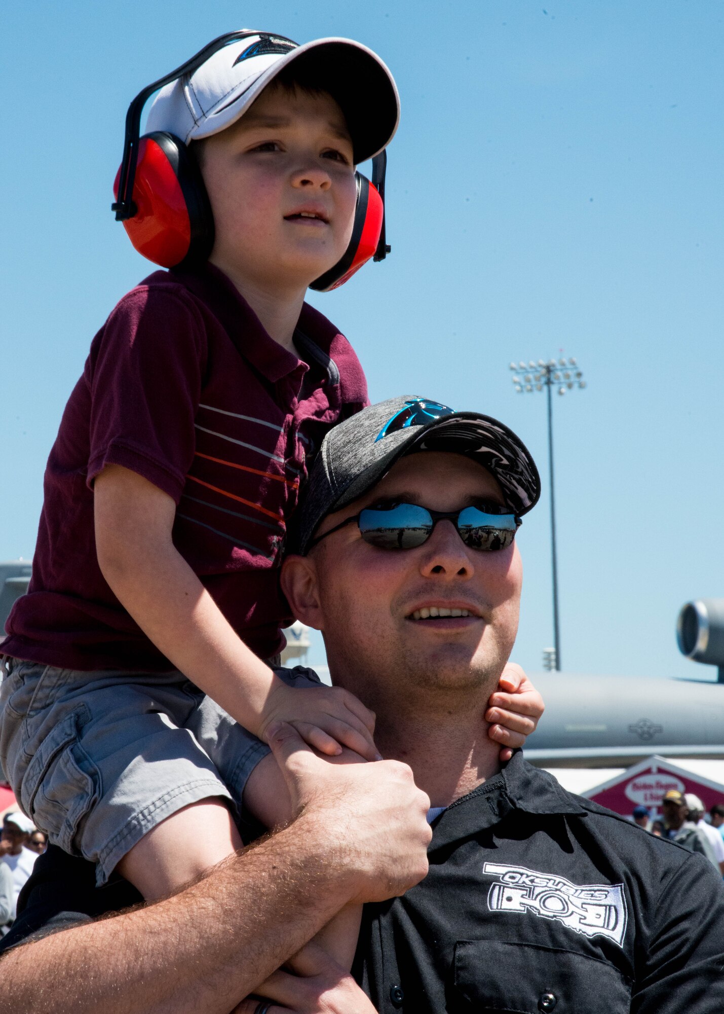 A father and son watch an aerial demonstration during the AirPower over Hampton Roads Open House at Langley Air Force Base, Va., April 24, 2016. The open house aims to educate the public on past and present Air Force aerial capabilities, increase recruiting and show appreciation to the local community.  (U.S. Air Force photo by Staff Sgt. J.D. Strong II)