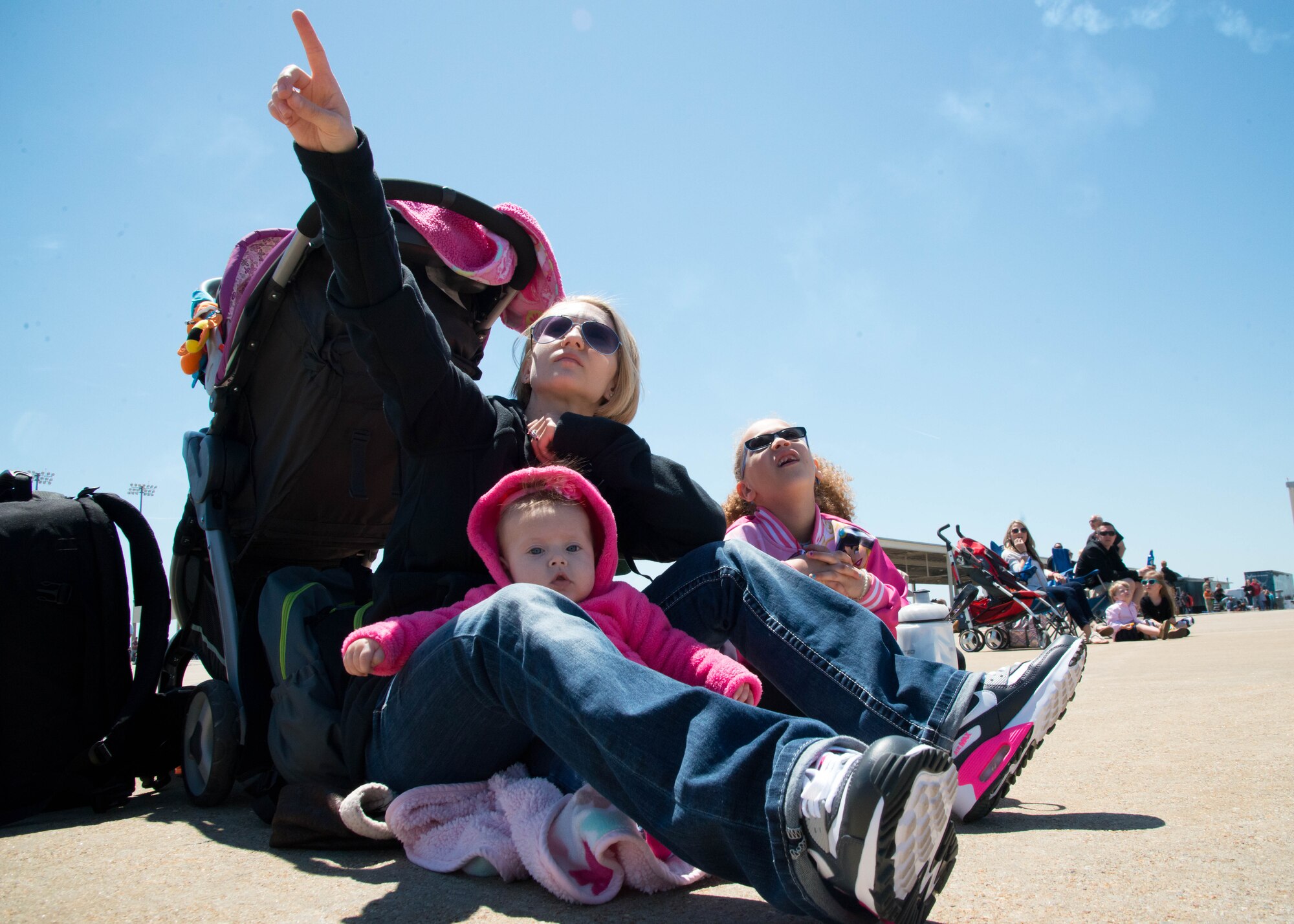 Spectators look to the sky as an aerial demonstration takes place during the AirPower over Hampton Roads Open House at Langley Air Force Base, Va., April 24, 2016. The open house gives military and civilian personnel the opportunity to get up-close-and-personal with various aircraft and witness the Air Force’s past and present capabilities in airpower. (U.S. Air Force photo by Staff Sgt. J.D. Strong II)