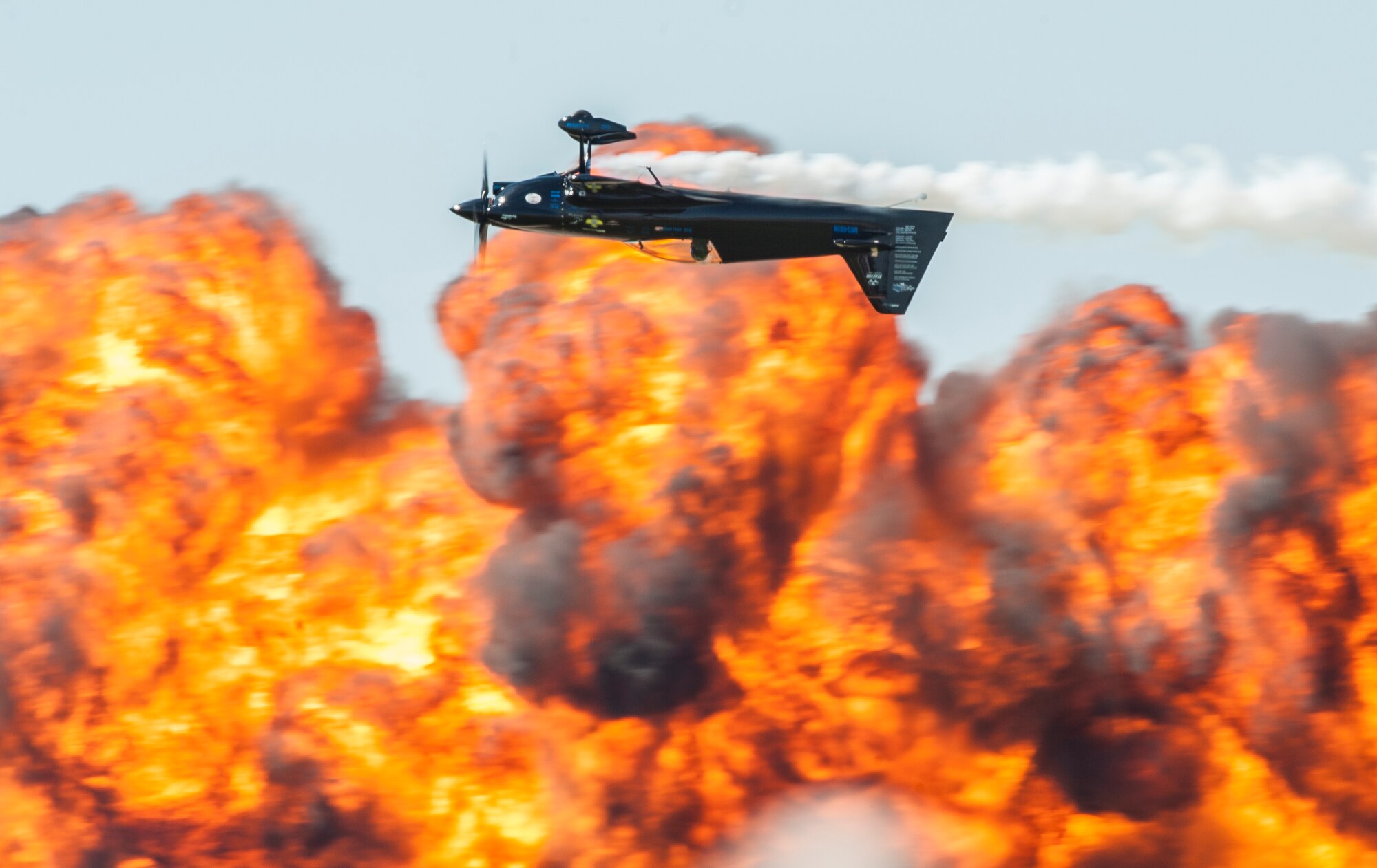 Air show pilot, Rob Holland, flies upside down over the SHOCKWAVE Jet Truck during the AirPower over Hampton Roads Open House at Langley Air Force Base, Va., April 24, 2016. The open house is a free and open to the public showcase of modern and historical military aircraft and civilian performers. (U.S. Air Force photo by Senior Airman Kayla Newman)
